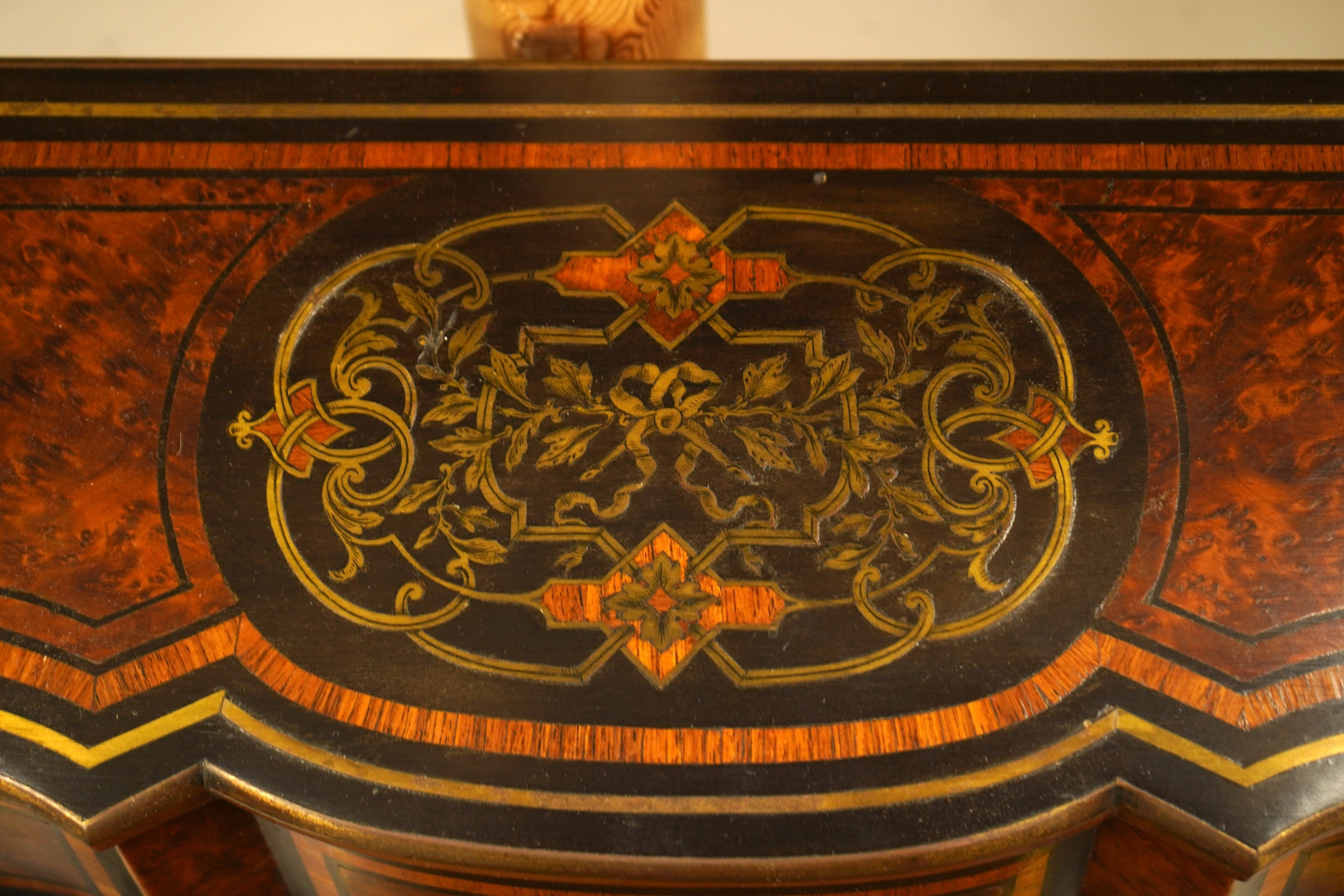 A 19th century French brass inlaid, tulip banded amboyna writing casket, the brass panel inscribed ‘Jane Lester’, 40cm wide